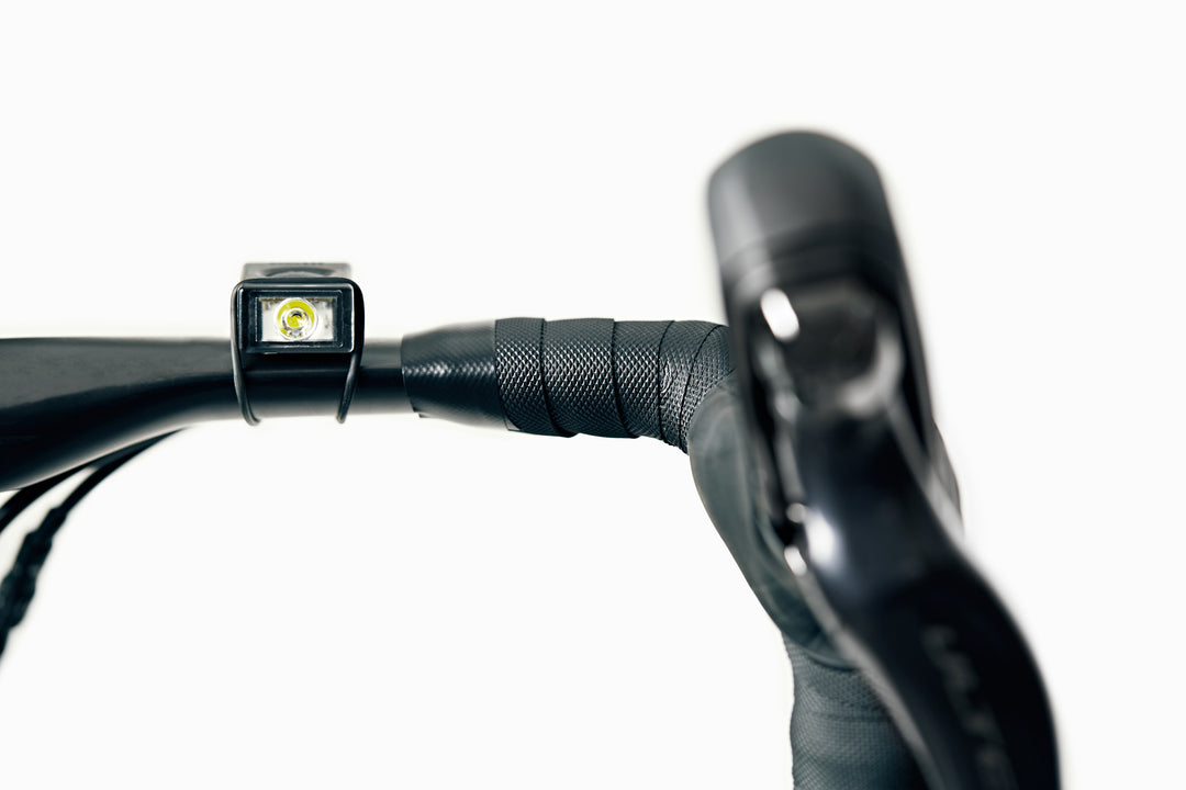 Block compact bicycle light on handlebar